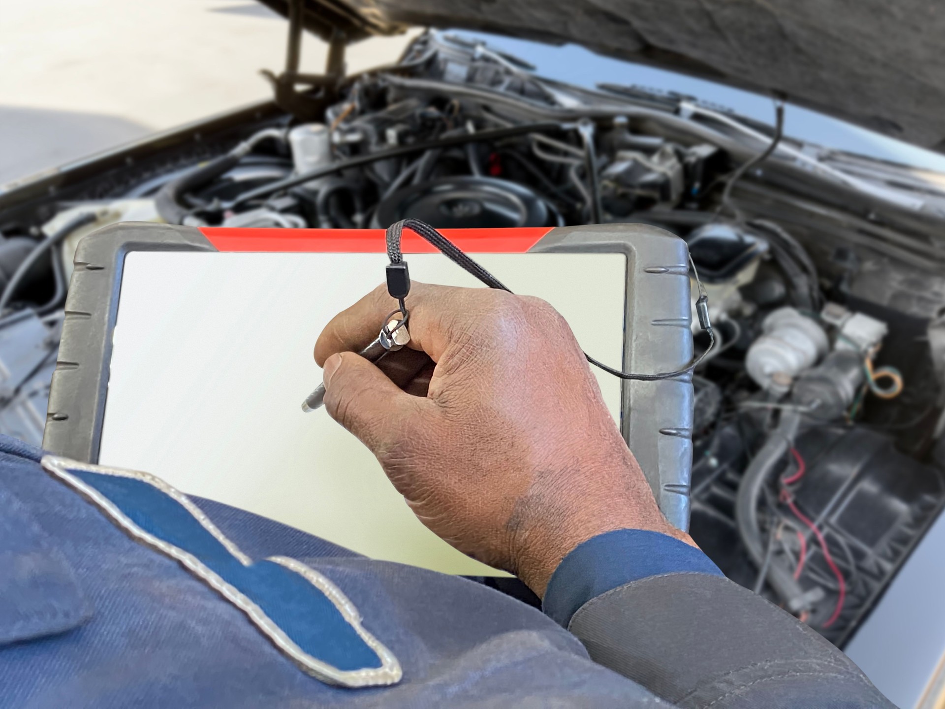 Auto mechanic using car diagnostic tool