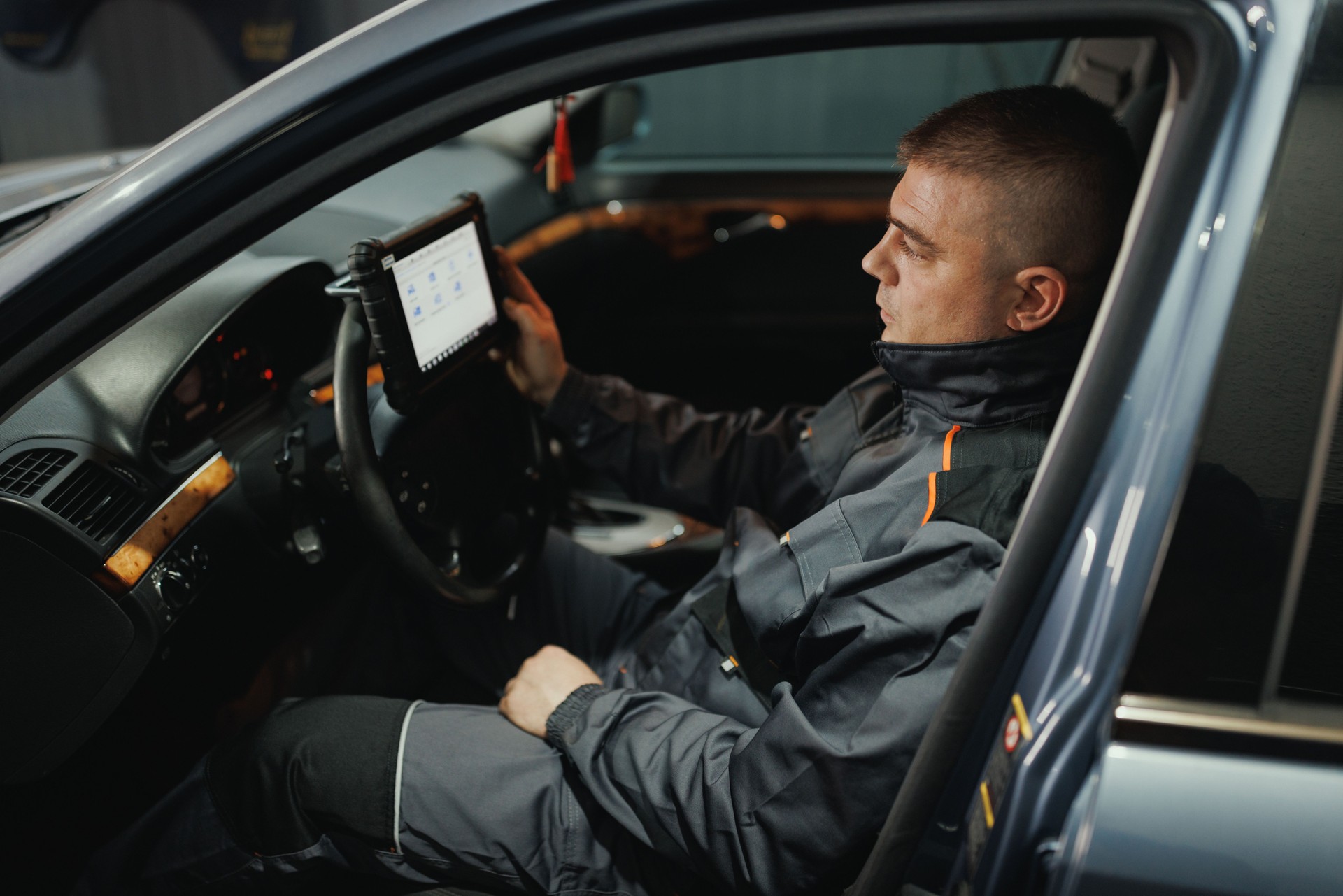 Mechanic Using Tablet for Car Diagnostics